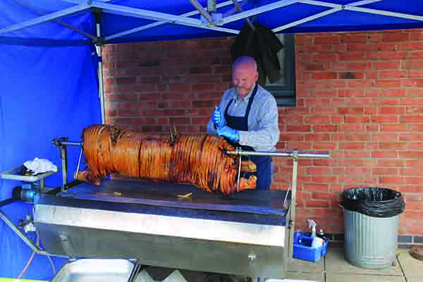 Andrew prepares a hog roast for NPA's 20th anniversary celebrations