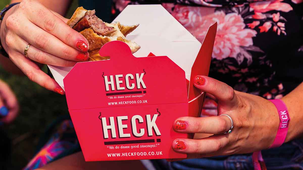 Woman eating roll with sausage