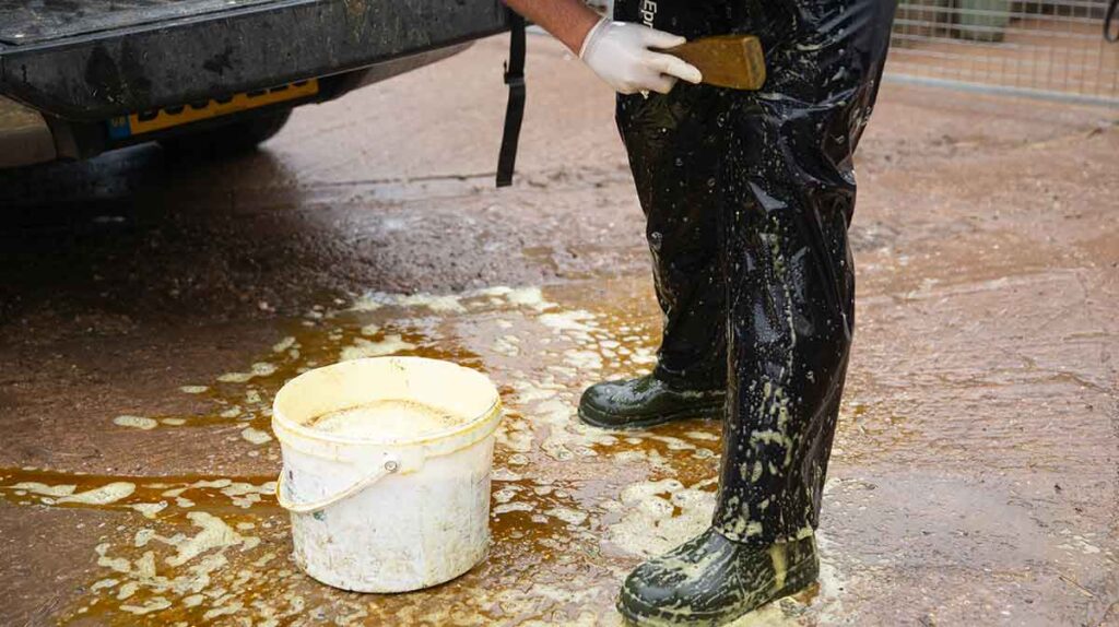 A vet disinfecting before going on to a farm