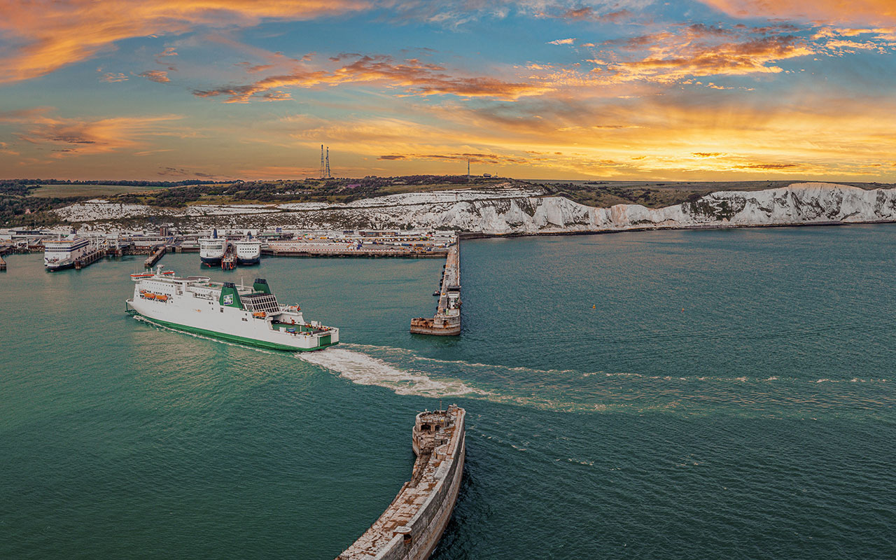 Aerial view of the Dover harbor with many ferries and cruise ships entering and exiting Dover, UK.