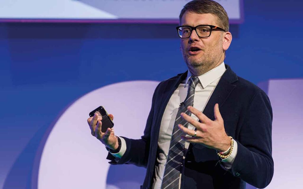 Craig Lewis standing at a podium