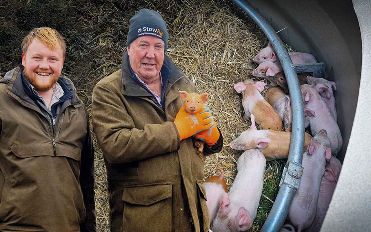 Jeremy Clarkson and Caleb holding piglet